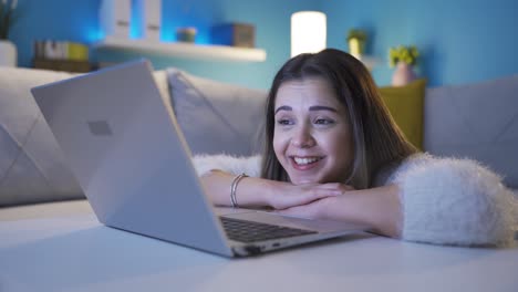 Happy-and-cheerful-young-woman-looking-at-laptop-with-focus.